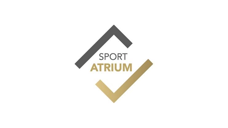Logo des Sport Atrium mit stilisierten geometrischen Formen in Grau und Gold auf hellem Hintergrund.